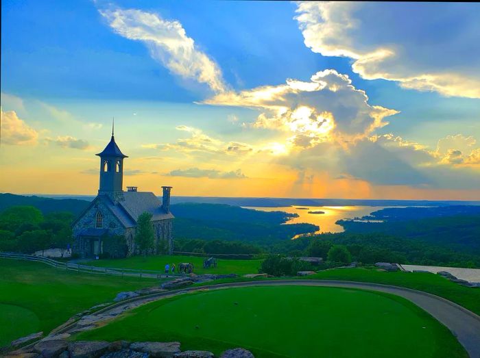 The Chapel of the Ozarks at sunset, framed by Table Rock Lake in Branson, Missouri.