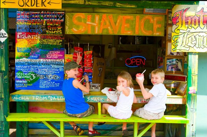 Children enjoying shave ice at Local Boy Shave Ice in Kihei, South West Maui.