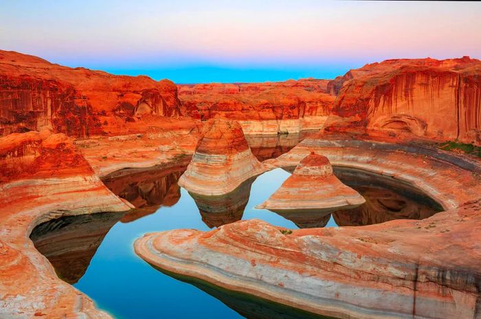 Reflection Canyon on Lake Powell showcases canyon walls rising majestically along the water's edge.