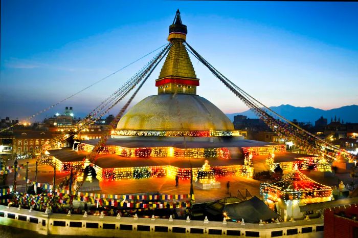 The magnificent stupa at Bodhnath during sunset, illuminated by numerous lamps