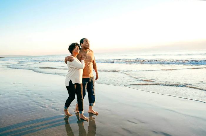 A couple enjoying a stroll along Tybee Beach in Georgia