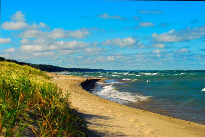 A deserted beach with powerful waves crashing against the shore