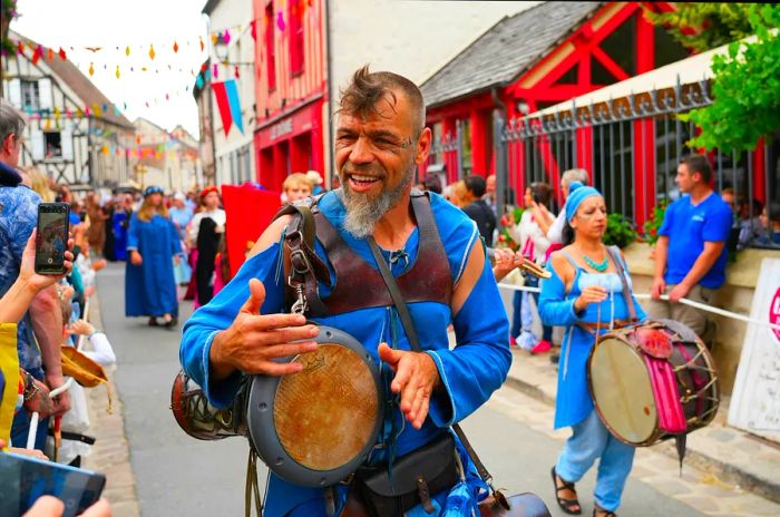 A lively group of musicians performing with djembe drums in the streets of Provins