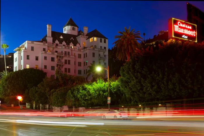 The facade of the Chateau Marmont hotel, with blurred cars streaming by, Los Angeles, California, USA