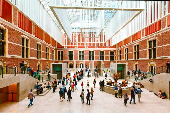 An expansive atrium at the heart of a bustling museum filled with visitors