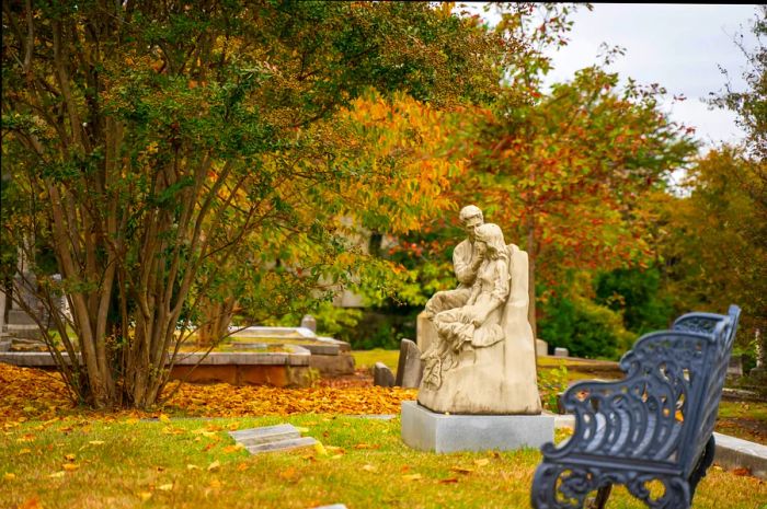 Historic gravestones and vibrant trees showcasing fall colors at Oakland Cemetery, East Side, Atlanta, Georgia, USA