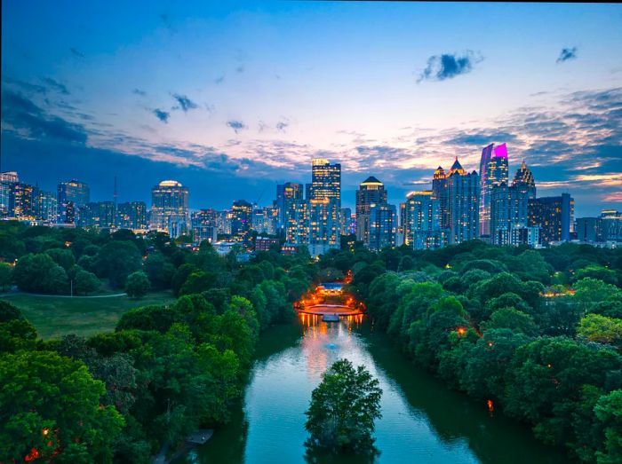 An aerial view of Piedmont Park at dusk, showcasing the skyline of downtown Atlanta in the background, Atlanta, Georgia, USA