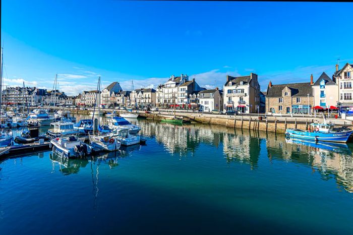 A view of Jules Sandeau Quay with boats anchored in the Le Pouliguen Channel at the coastal resort of La Baule in Southern Brittany, Loire-Atlantique.