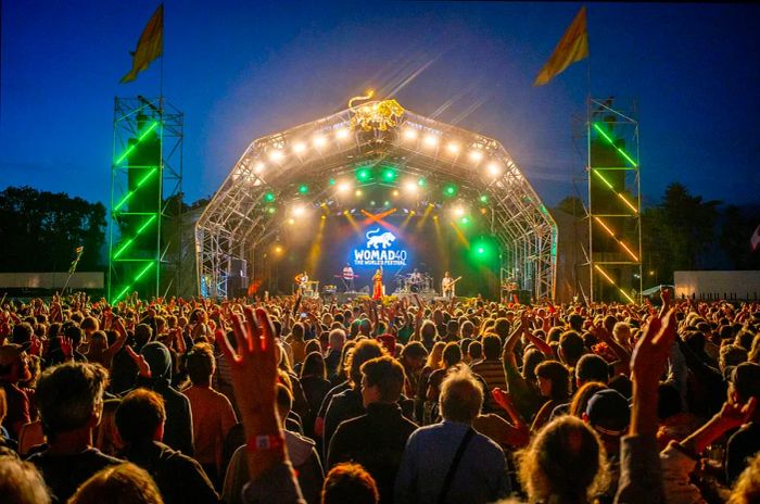 Yellow flags flutter at the Womad festival site as the sun sets on the first day of its 40th anniversary celebration.jpg