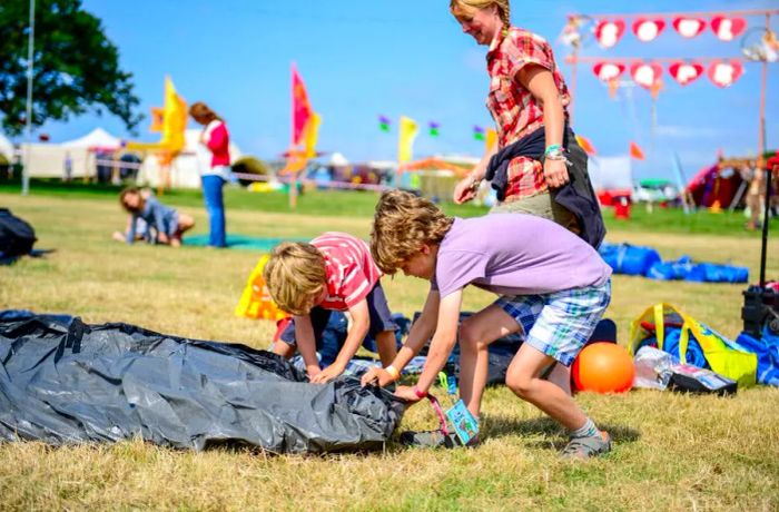 Festival attendees setting up their tents on the opening day of Camp Bestival