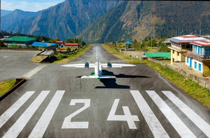 An airplane sits on the runway at Tenzing-Hillary Airport in Lukla, Nepal.