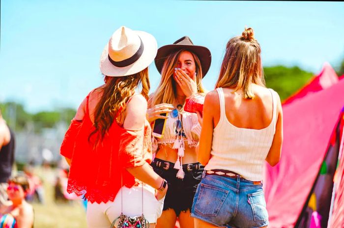 A small group of women enjoying the Isle of Wight Festival during the summer. Atmosphere, Festival Photographer, Music