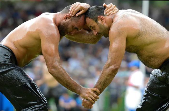 Two oil wrestlers competing at the Kirkpinar oil wrestling festival in Edirne, Istanbul