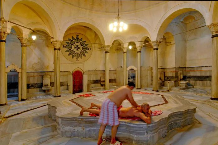 A visitor enjoying a massage at a hammam (Turkish bath) in Istanbul