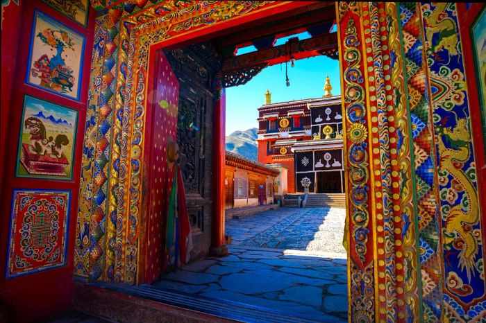 An intricately designed entrance in a temple complex adorned with vibrant patterns around the frame