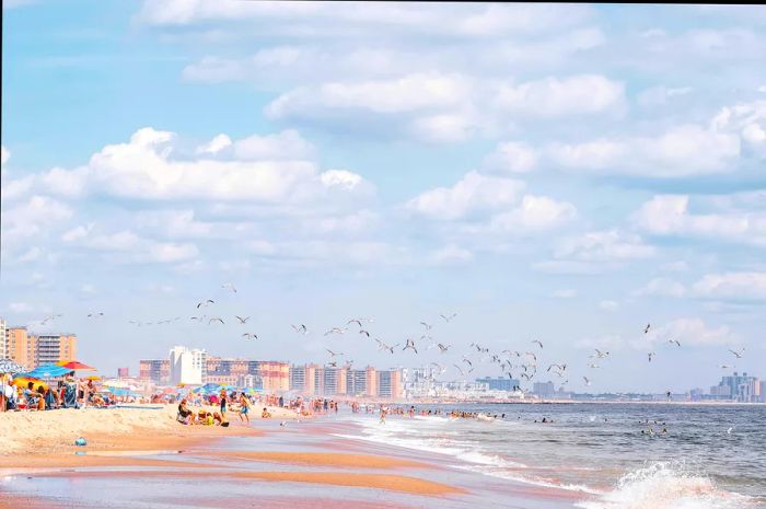 Rockaways, Queens, New York beach front and ocean during summer. Blue skies and white sand.