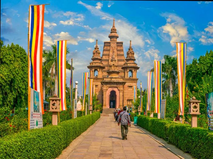 A person approaches the entrance of a monastery and temple complex.