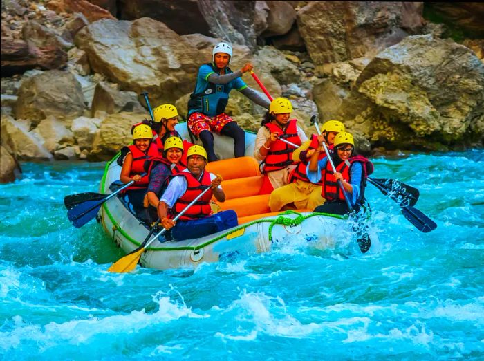 Smiling faces as they tackle the thrill of whitewater rapids in a small boat.