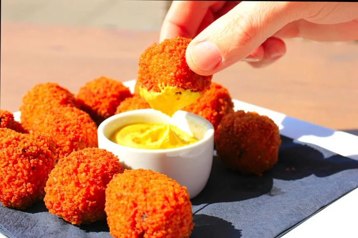 Dutch bitterballen (crispy fried meatballs) served warm with mustard.