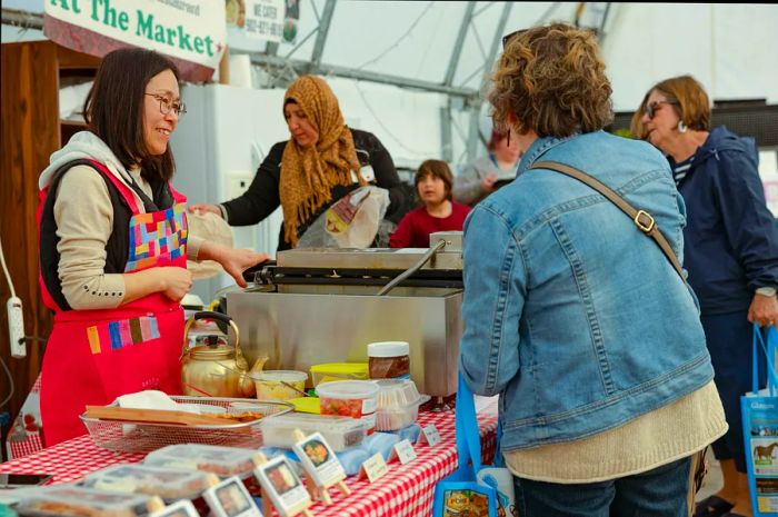 A vendor offers food at the Farmer's Market in downtown New Glasgow, Pictou County, Nova Scotia, Canada.