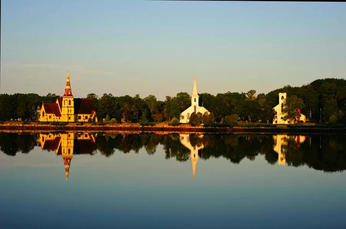 The iconic trio of churches reflecting in the water, Mahone Bay, Nova Scotia, Canada