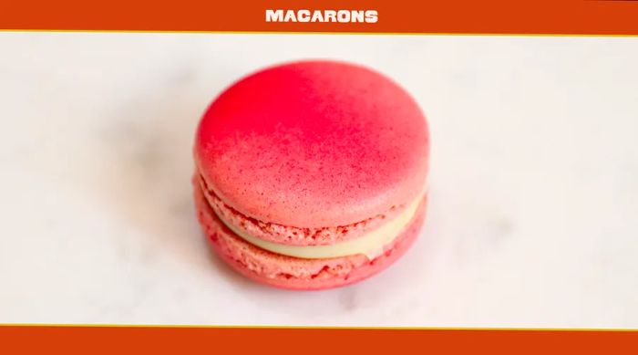 A close-up of a pink macaron