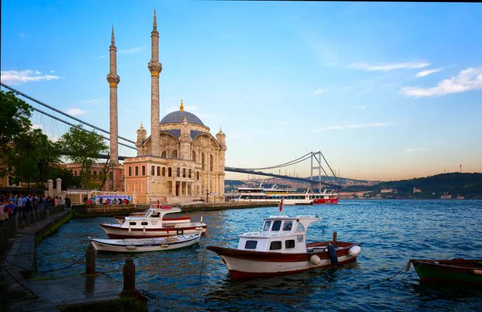 Boats glide through the Bosphorus Strait near Ortaköy Mosque in Beşiktaş, Istanbul.