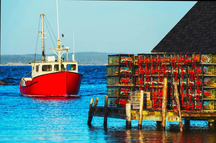 A lobster boat heads towards the wharf in Peggy's Cove, Nova Scotia, Canada