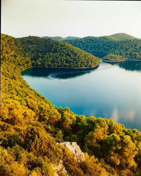 Sunlight dances on the trees and waters of Veliko Lake in Mljet.