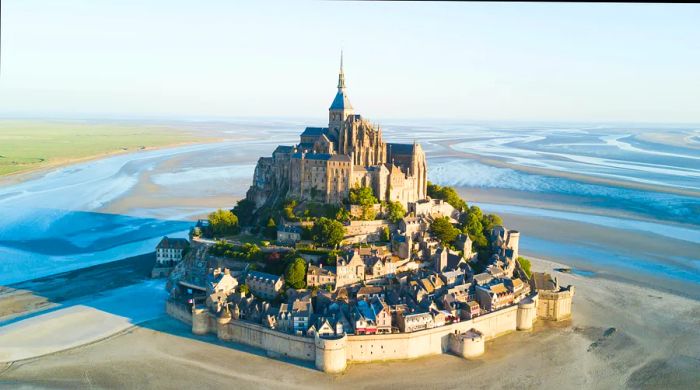 The breathtaking tidal island of Le Mont Saint-Michel at dusk, bathed in twilight.