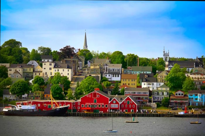 A waterfront featuring buildings including a striking red fishing museum