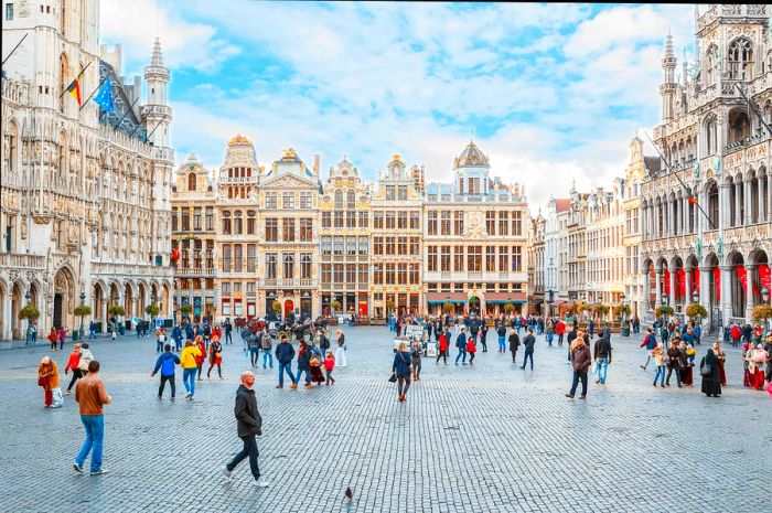 Pedestrians enjoying a bustling city square with cobblestone streets