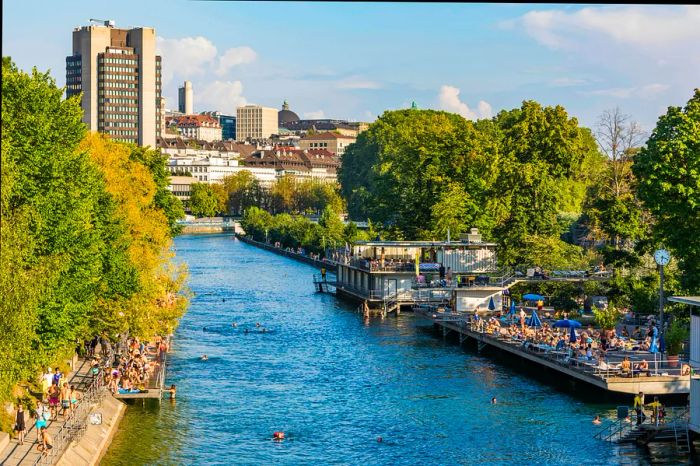 People enjoying a swim in the river in the heart of Zurich