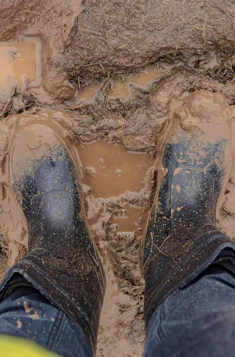 POV shot of a pair of wellington boots stuck in mud © Dmitri Fedorov / Shutterstock