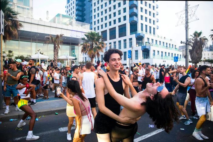 Young people celebrate in the streets during Pride festivities in Tel Aviv, Israel.