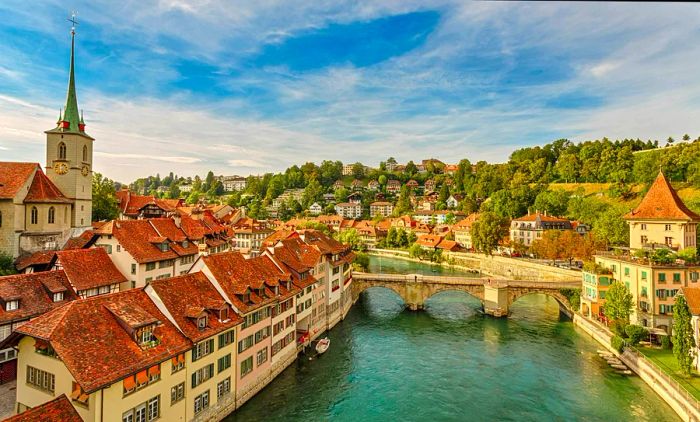 An old town with a turquoise river flowing through it