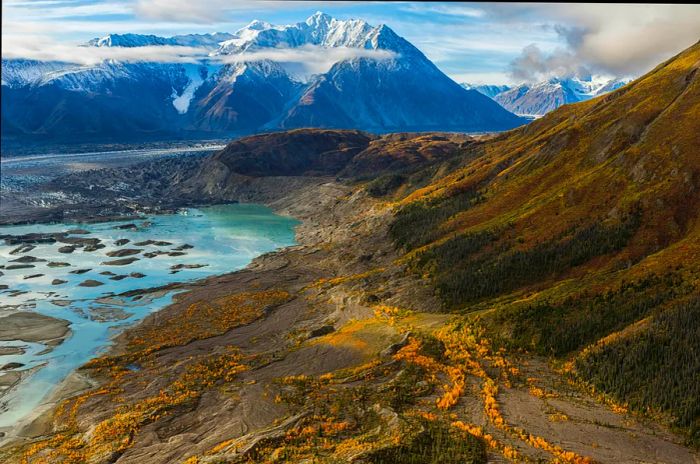 A snow-covered peak rises above an untouched landscape