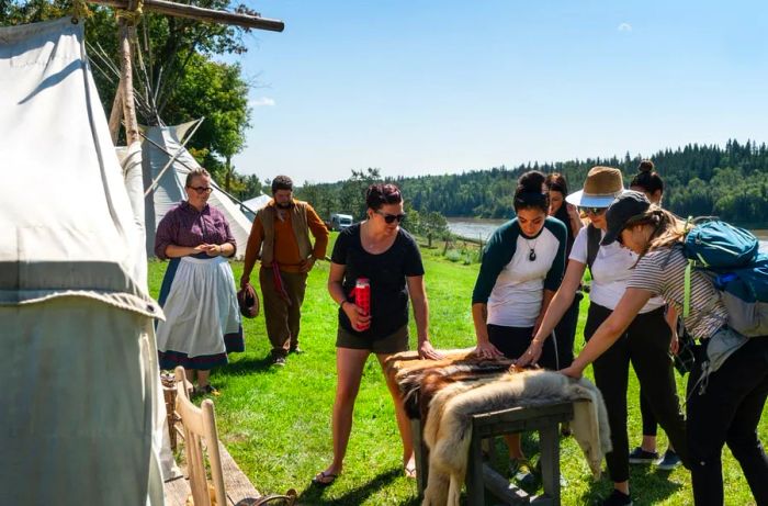 A group observes animal pelts at Métis Crossing, Edmonton.