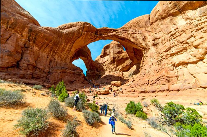 Double Arch in Arches National Park with visitors