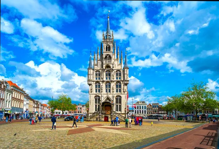 A Gothic town hall graces a bustling city square