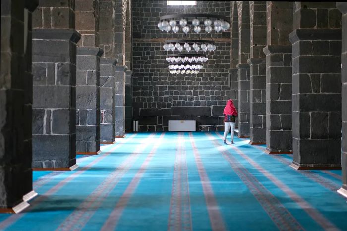 A woman explores the interior of the Great Mosque in Diyarbakır, Turkey.