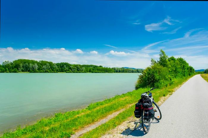 Summer scene along the Danube cycle path in Germany with a solitary bike.