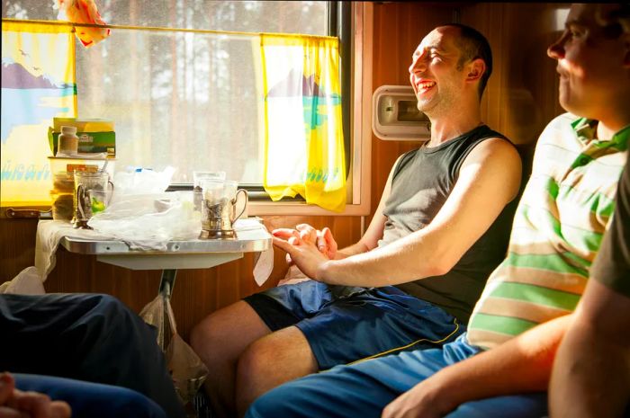 Men sharing a sleeper cabin aboard the BAM train service to Tynda.