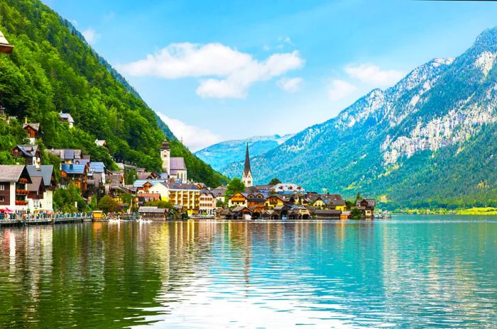 A picturesque alpine village with a church beside a lake