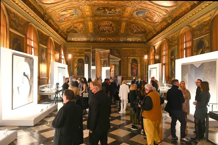 Visitors gather for the opening of an art exhibition in the reading room of the Renaissance Biblioteca Nazionale Marciana, Venice, Veneto, Italy