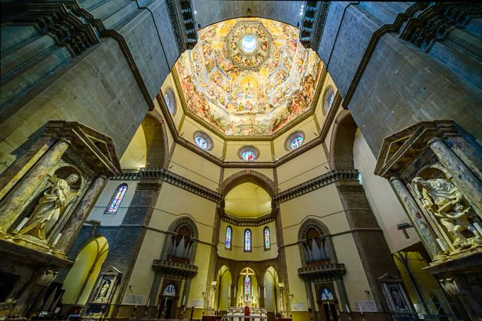 Gazing up at the frescoed dome within Florence's Duomo, the Cathedral of Santa Maria del Fiore