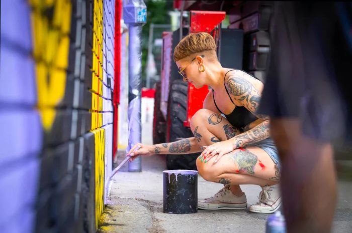 An artist paints during Festival Mural in Montréal, Québec, Canada