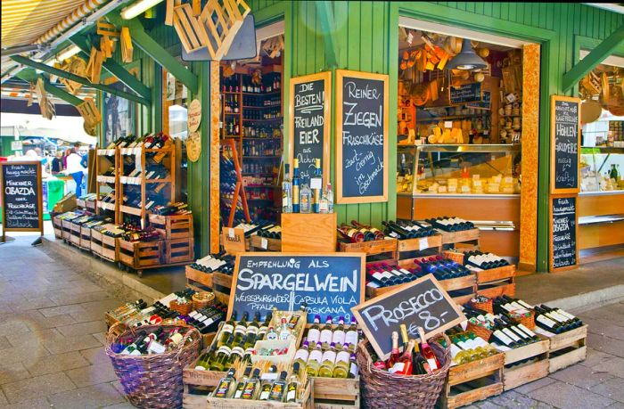 Cheese and drinks displayed at a stall in Munich's Viktualien open-air market.