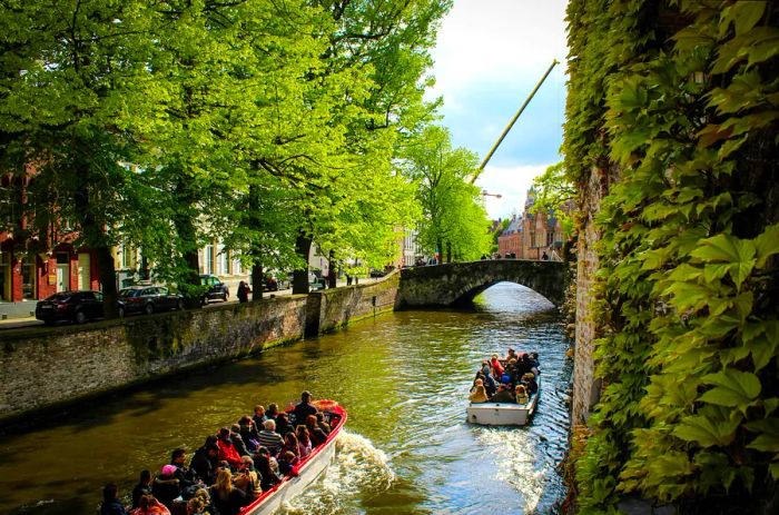 Two small canal boats ferry tourists around the charming canals of this quaint city.