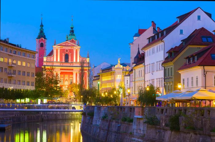 A river flowing through a quaint, low-rise European city